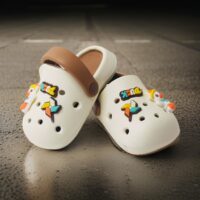 A pair of  Duck design crocs Rubber upper pull-on flat Cushioned footbed Patterned rubber outsole